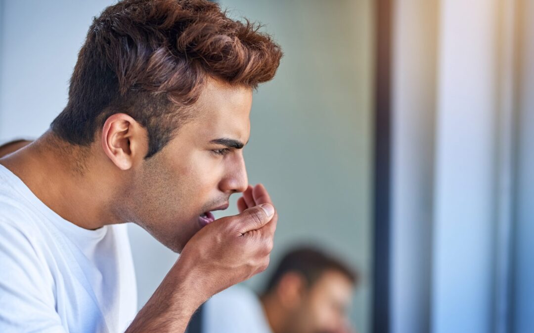 Man holding his mouth due to tooth pain